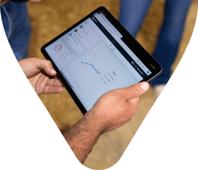 Person holding a tablet displaying data analytics.
